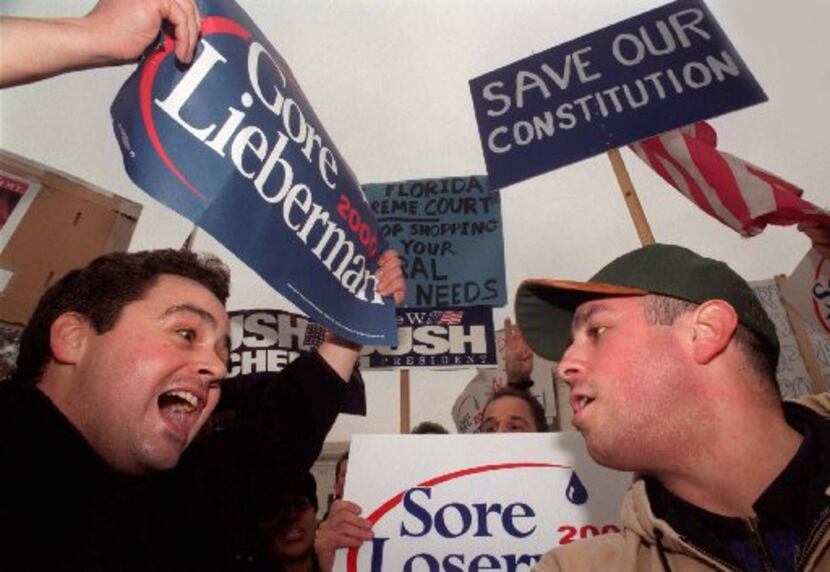 In this file photo from 2000, Al Gore supporter John Paul Sutliff (left) argues with George...