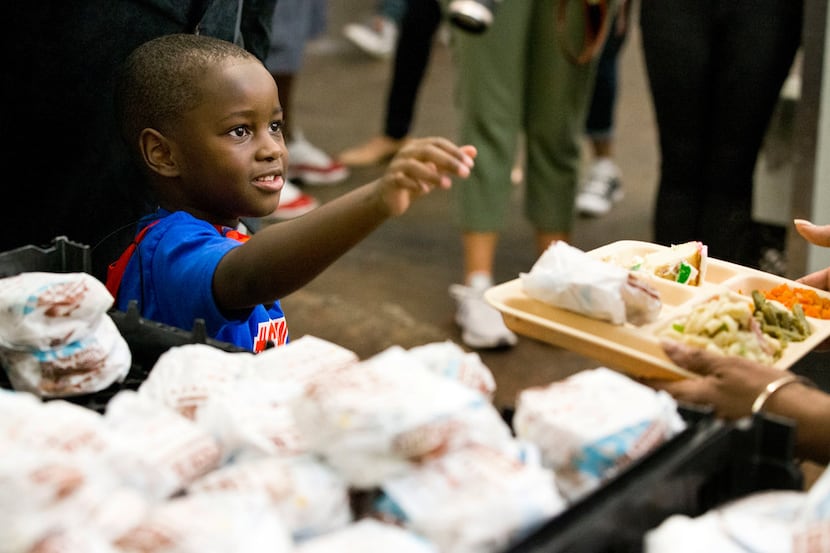 "President" Austin Perine, 4, looked at a homeless person after handing him a sandwich...