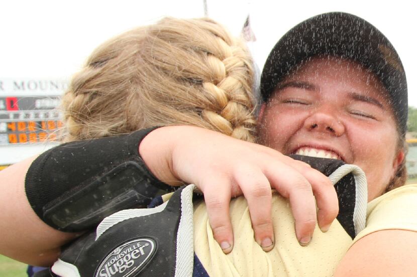 Keller pitcher Dylann Kaderka (22), right, shares a hug with catcher Courtney Cagle after...