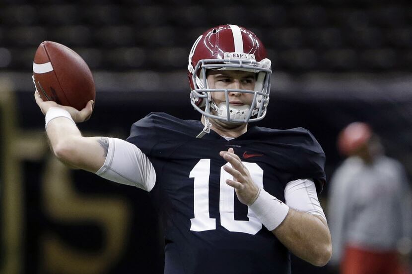 Alabama quarterback AJ McCarron (10) passes during NCAA college football practice at the...