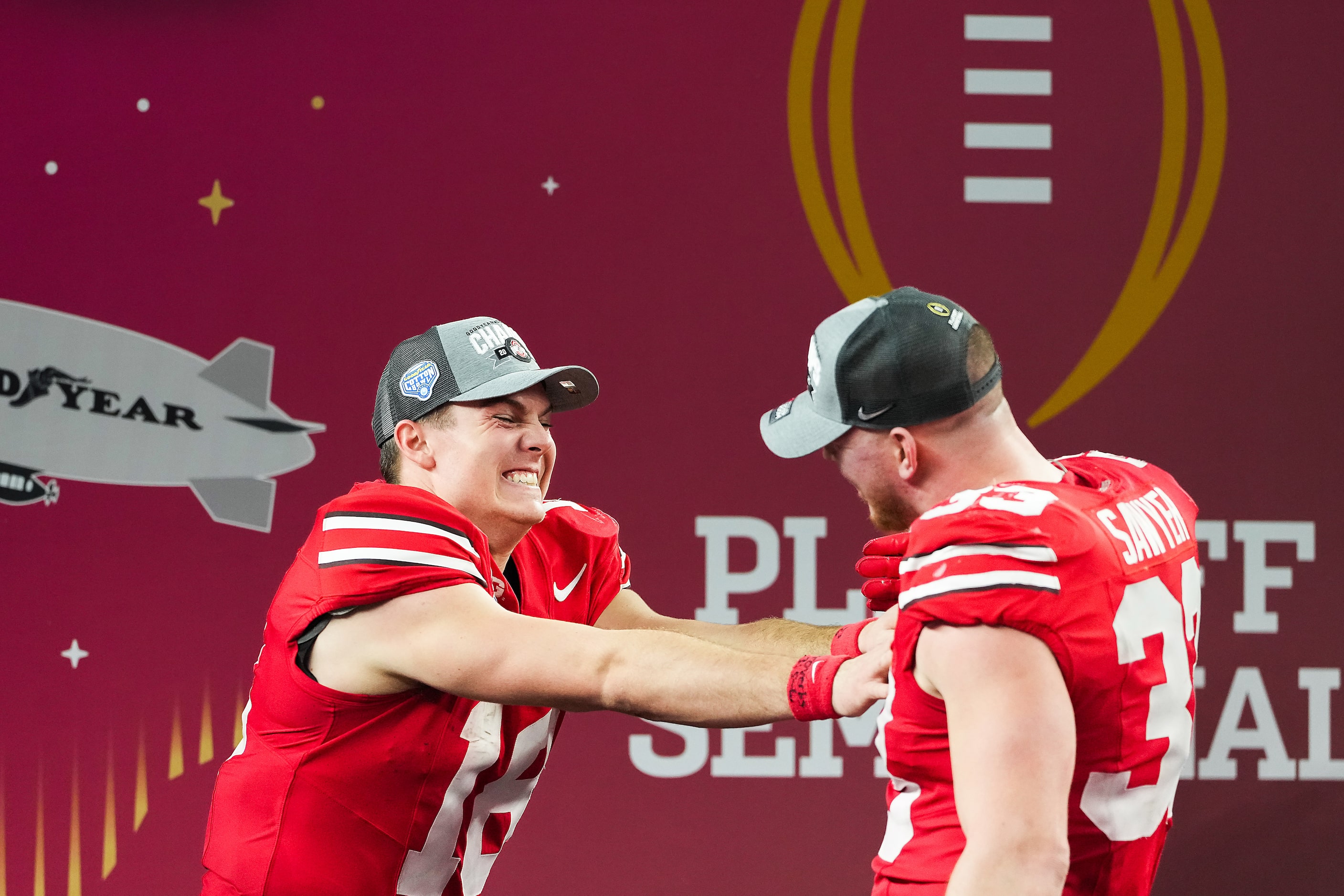 Ohio State quarterback Will Howard (18) celebrates with defensive end Jack Sawyer (33) after...