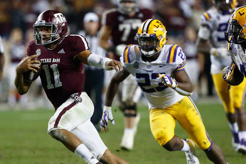 COLLEGE STATION, TEXAS - NOVEMBER 24: Kellen Mond #11 of the Texas A&M Aggies rushes past...