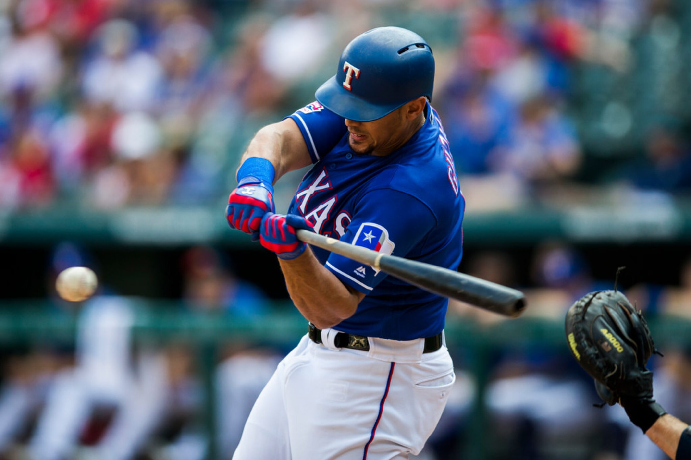 Texas Rangers first baseman Ronald Guzman (11) bats during the eighth inning of an MLB game...