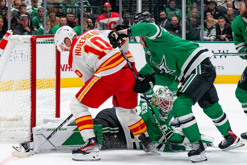 Dallas Stars goaltender Jake Oettinger (29) attempts to lie out in front of the goal to stop...