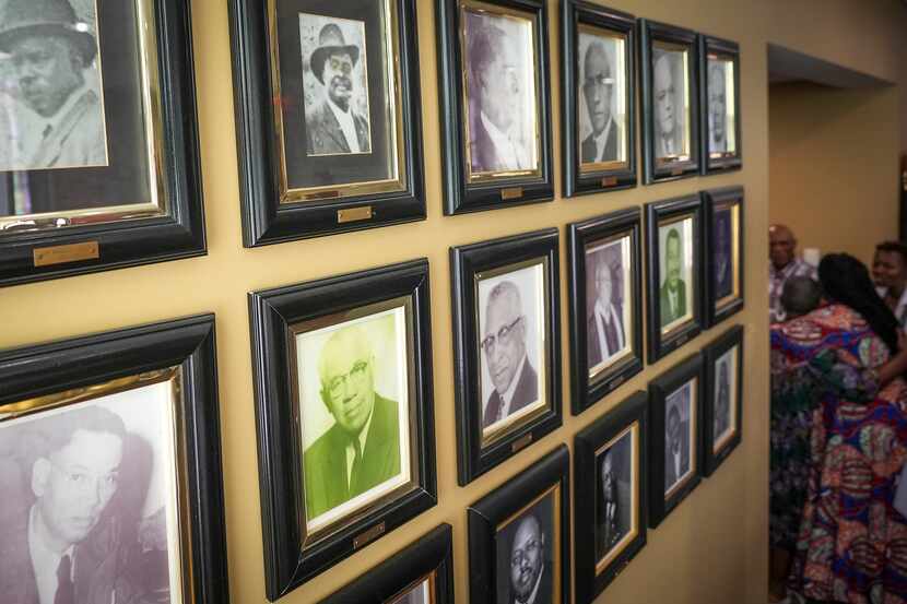 A wall at St. Paul United Methodist Church shows photos of the church’s pastors through the...