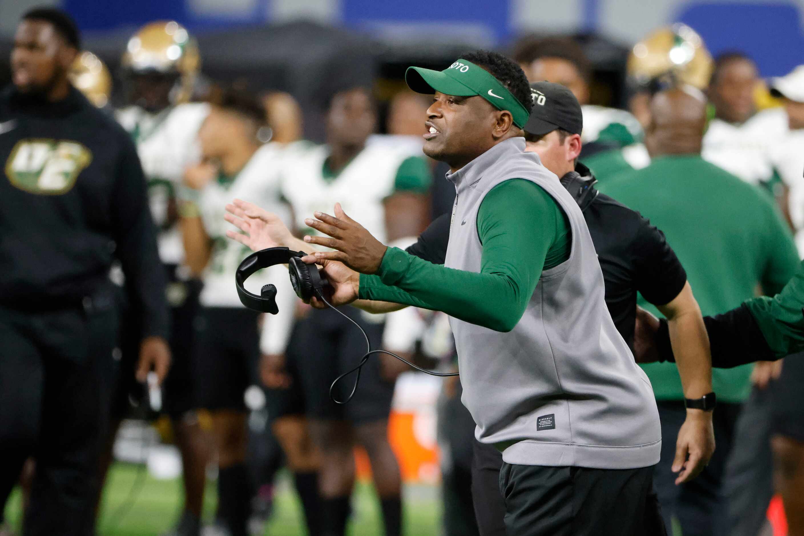 DeSoto head football coach Claude Mathis directs his team from the sideline as they played...