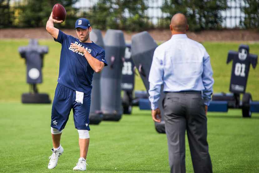 Dallas Cowboys quarterback Tony Romo throws passes to former Cowboys wide receiver Miles...