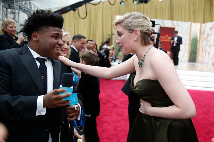 Greta Gerwig, right, talks to Jerry Harris on the red carpet at the Oscars on Sunday, Feb....