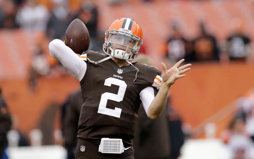 FILE - In this Dec. 14, 2014 file photo, Cleveland Browns quarterback Johnny Manziel warms...