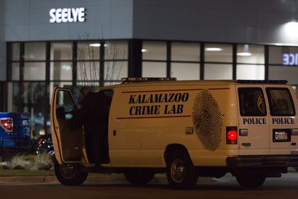  An officer with the Kalamazoo Crime Lab leaves the scene of a random shooting on Sunday,...