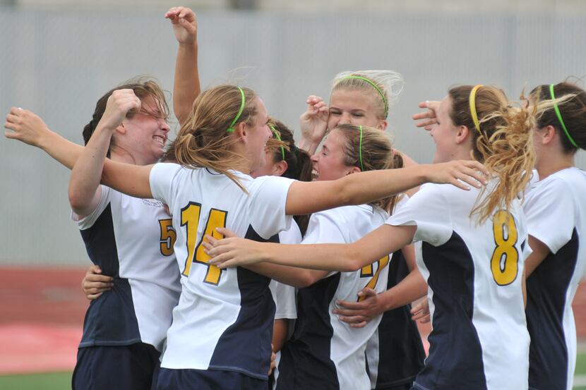 Highland Park players celebrate their third goal over Creekview scored by senior Megan...