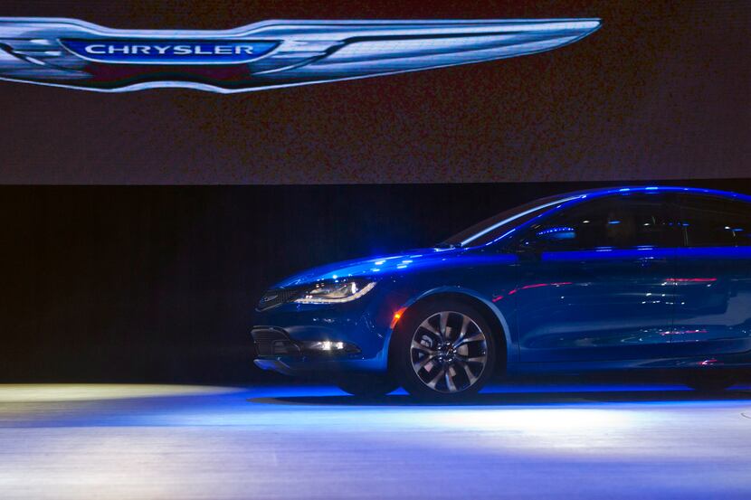 FILE - In this Monday, Jan. 13, 2014, file photo, a Chrysler 200 sedan drives on stage at...