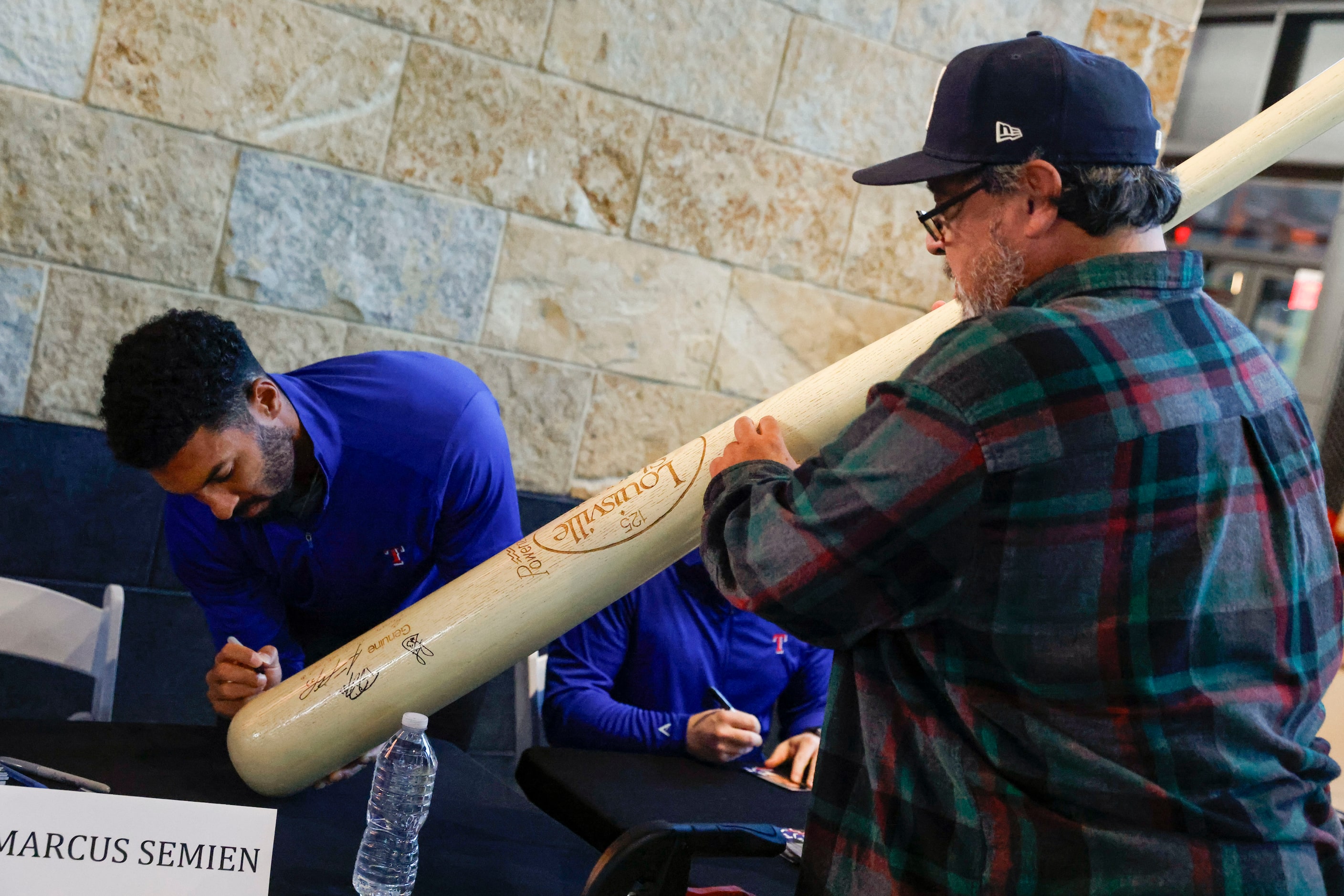 Texas Rangers second baseman Marcus Semien gives an autograph to Mike Navarro of Waxahachie...