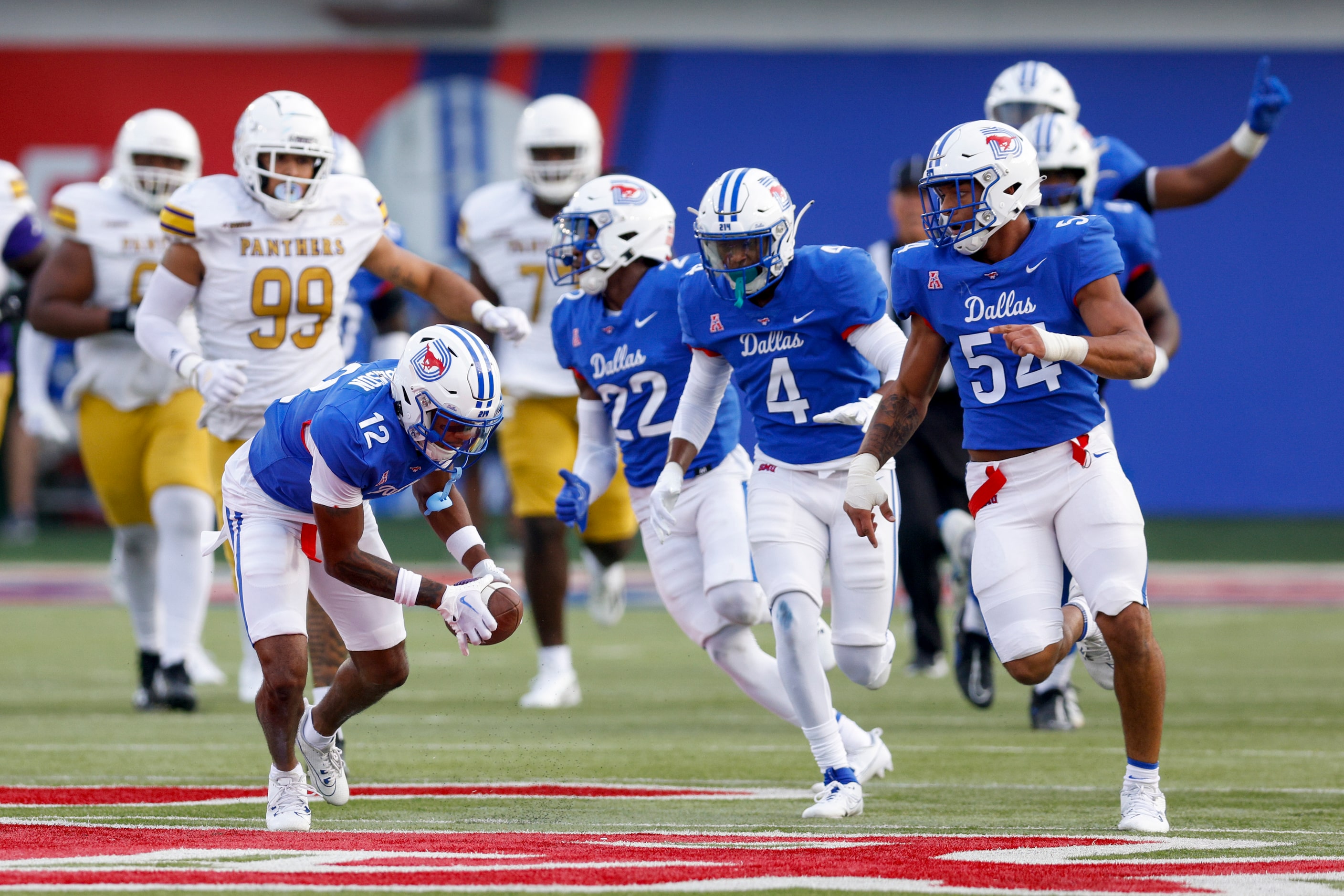 SMU cornerback Chris Megginson (12) scoops up the ball after a blocked field goal and...