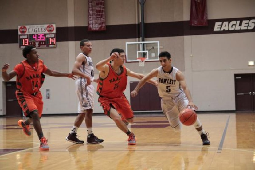 
Rowlett senior Tristan Munoz drives into the lane against Garland Naaman Forest. Rowlett is...