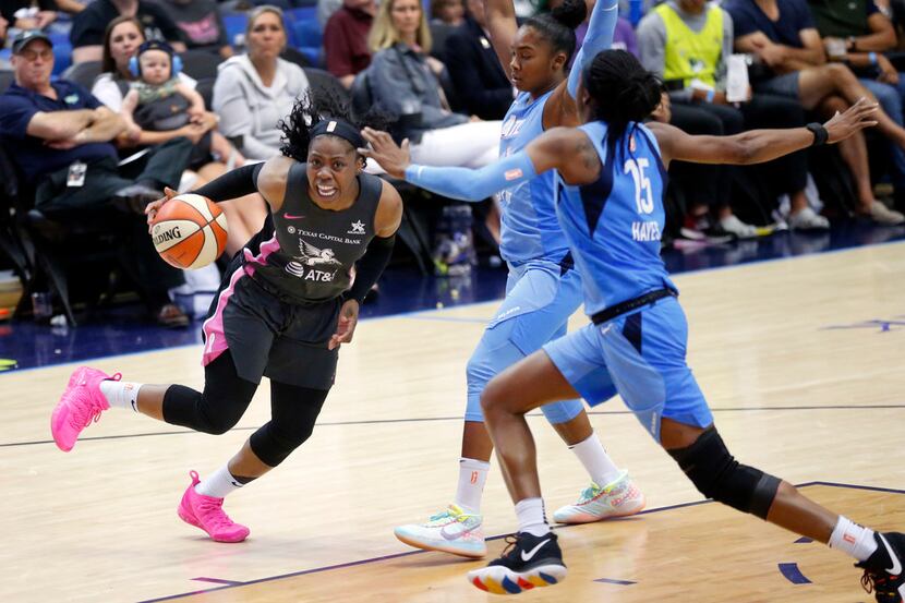 Dallas Wings guard Arike Ogunbowale (24) skips around Atlanta Dream guards Alex Bentley (20)...