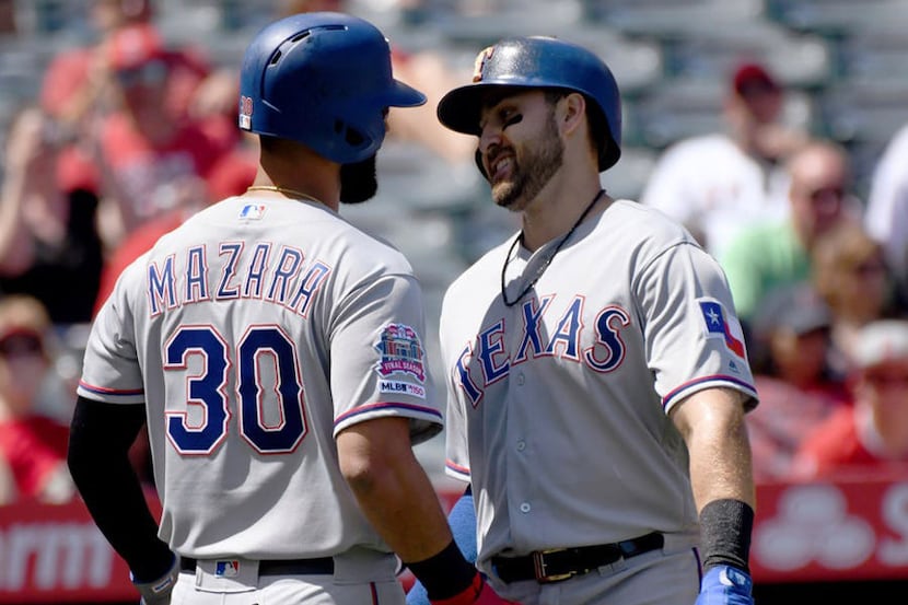Texas Rangers' Joey Gallo, right, is greeted at home plate by Nomar Mazara after hitting a...