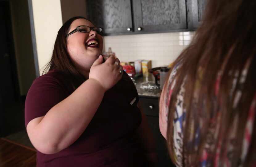 Melissa Prosser laughs with Shayla Halley at the Ebby House in Dalla. The house helps young...