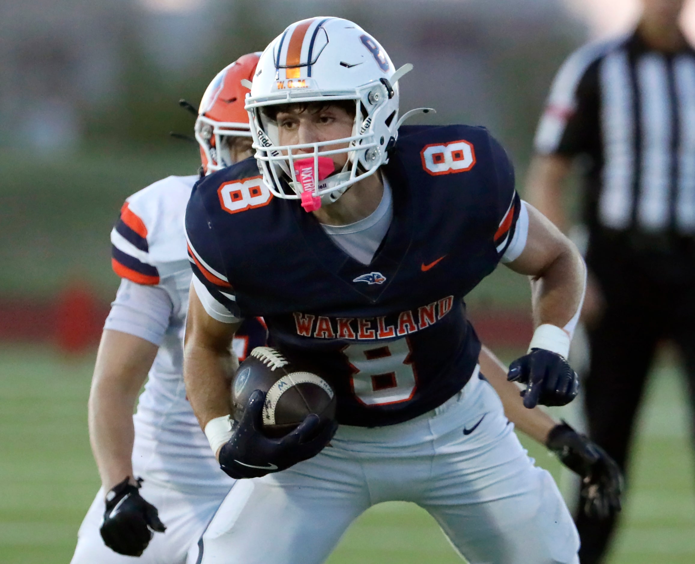 Wakeland High School wide receiver Ryder Treadway (8) looks for room to run after the catch...