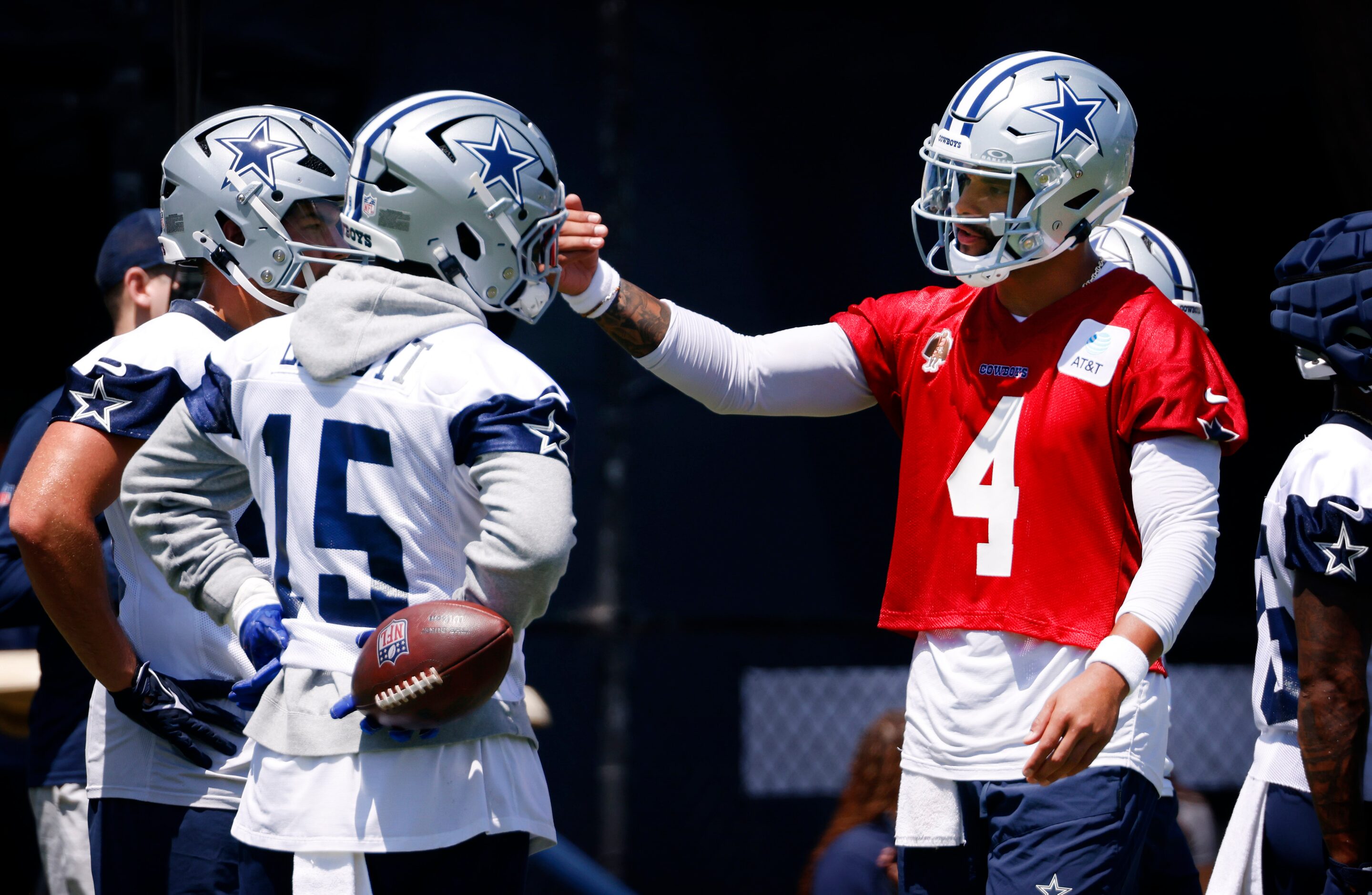 Dallas Cowboys quarterback Dak Prescott (4) works with running back Ezekiel Elliott (15)...