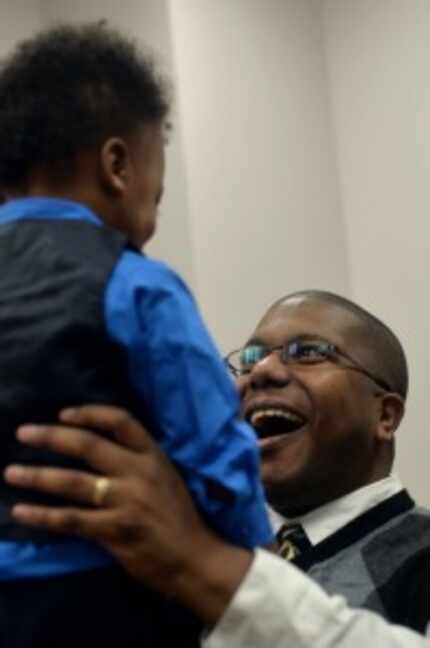  Jeffrey Coleman, right, smiles at his newly adopted son Lawrence Coleman, 2, both of...