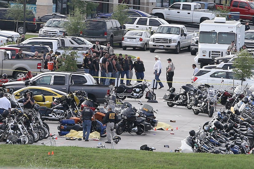 FILE - In this May 17, 2015 file photo, authorities investigate a shooting in the parking...