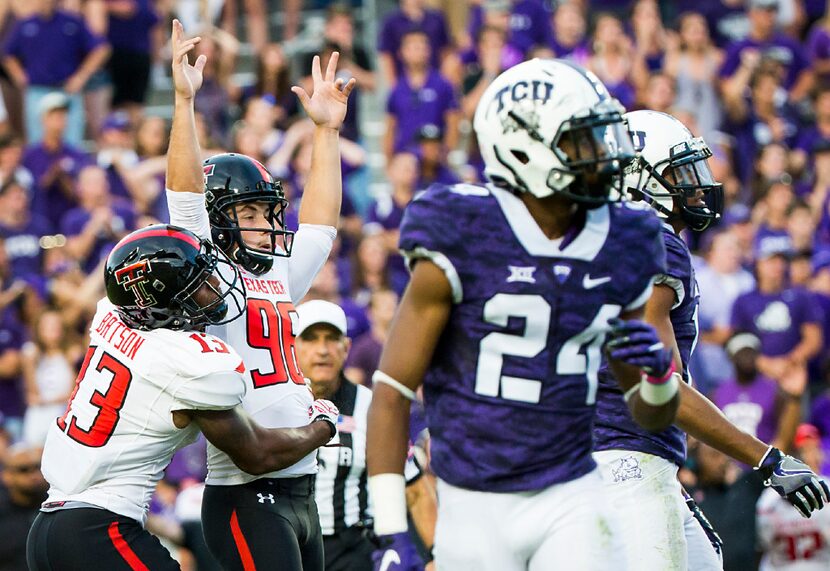 Texas Tech place kicker Clayton Hatfield (96) celebrates with holder Cameron Batson (13)...