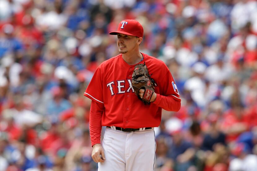 Texas Rangers' Tanner Scheppers stands on the mound in the second inning of a baseball game...