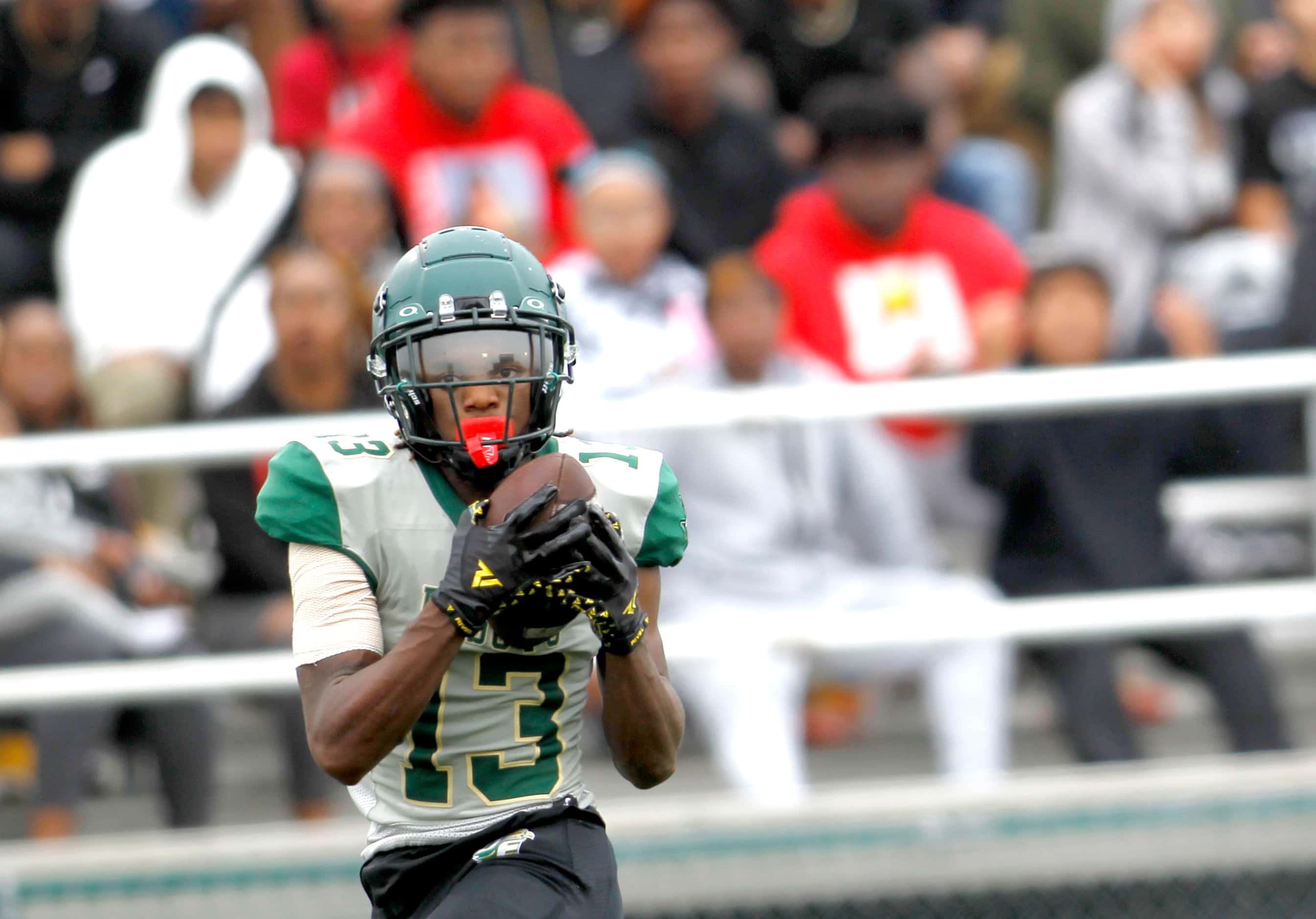 DeSoto receiver Daylon Singleton (13) pulls in a long touchdown pass in front of Duncanville...