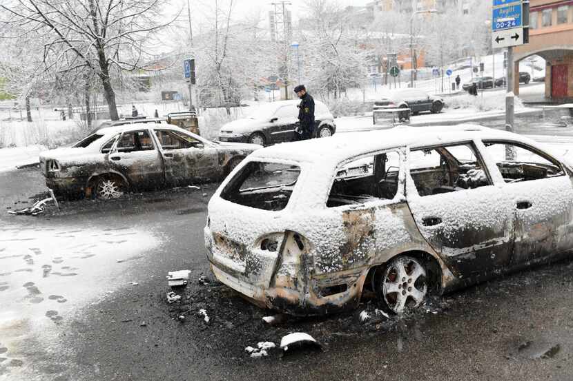 Several cars were torched during riots Monday in a Stockholm suburb known for its large...