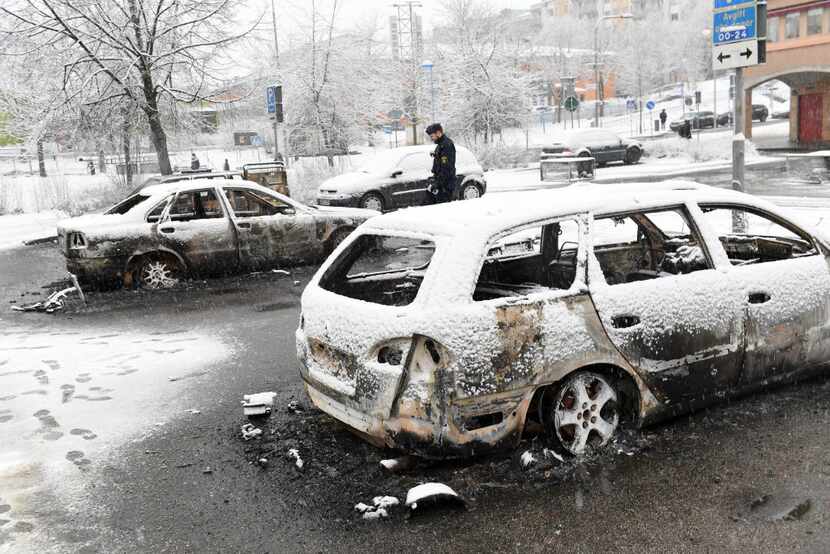 Several cars were torched during riots Monday in a Stockholm suburb known for its large...