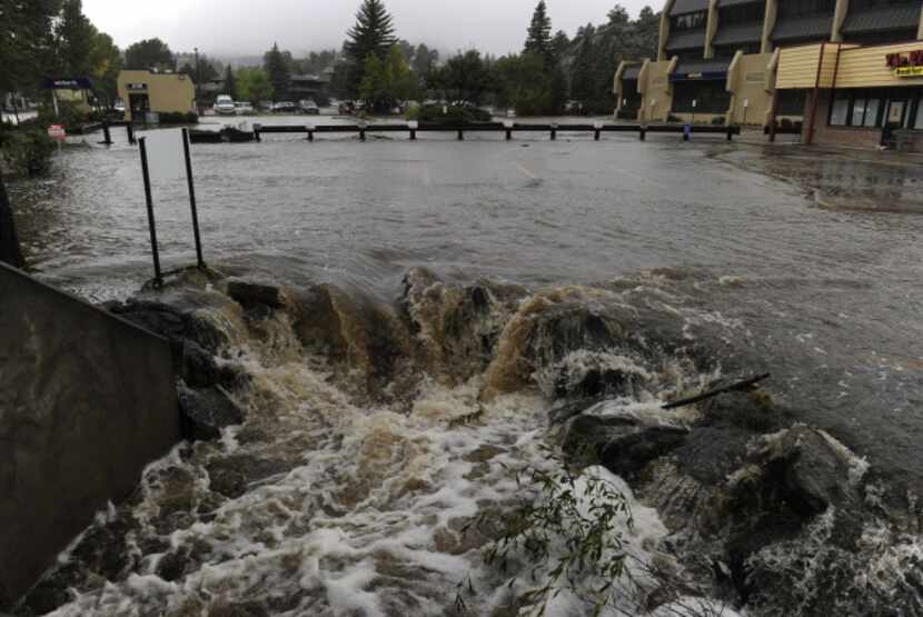 A heavy flow of water pours out of a parking lot on E. Elkhorn Ave. overwhelming a culvert...