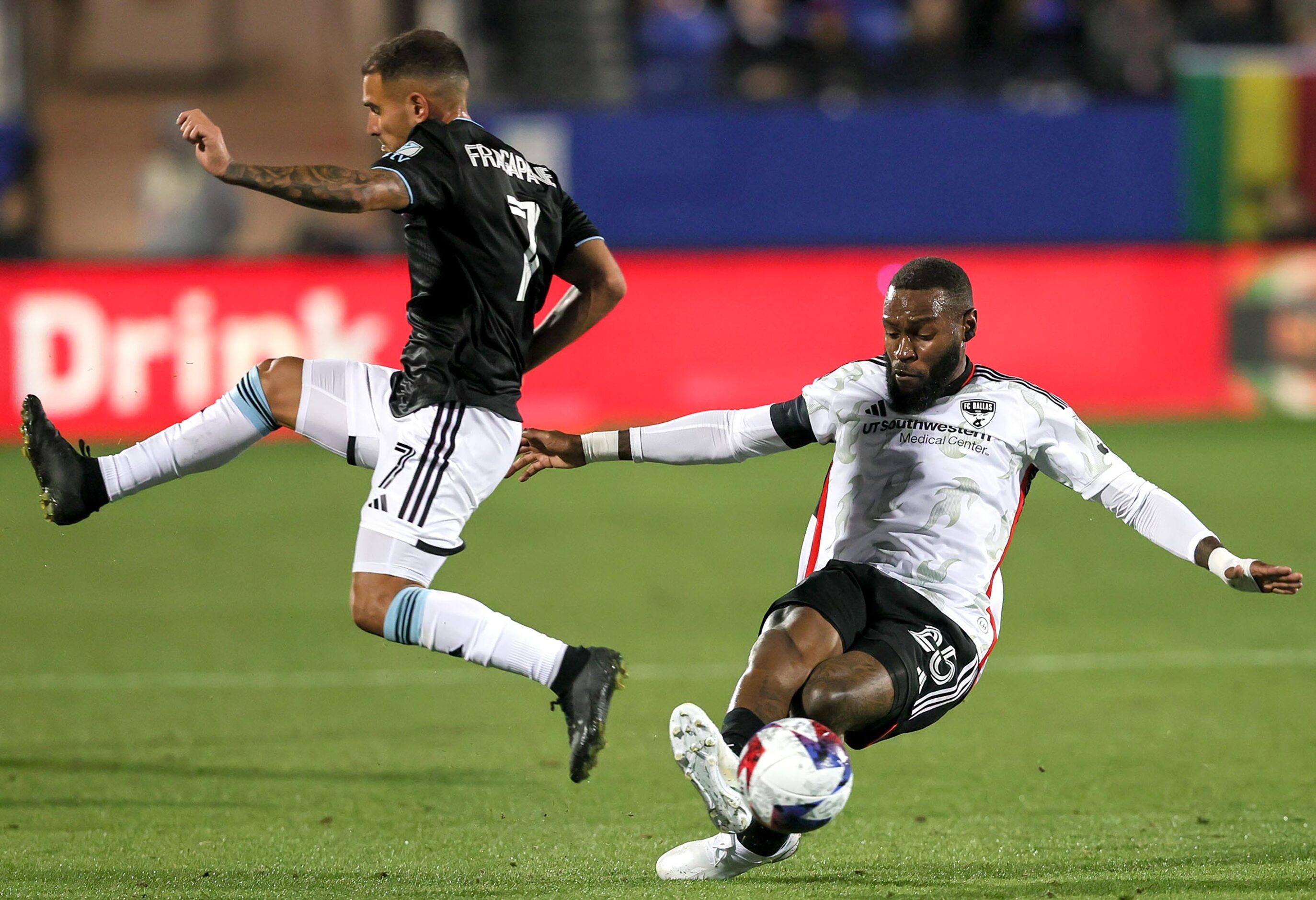 FC Dallas defender Sebastien Ibeagha (25) takes the ball away from Minnesota United...