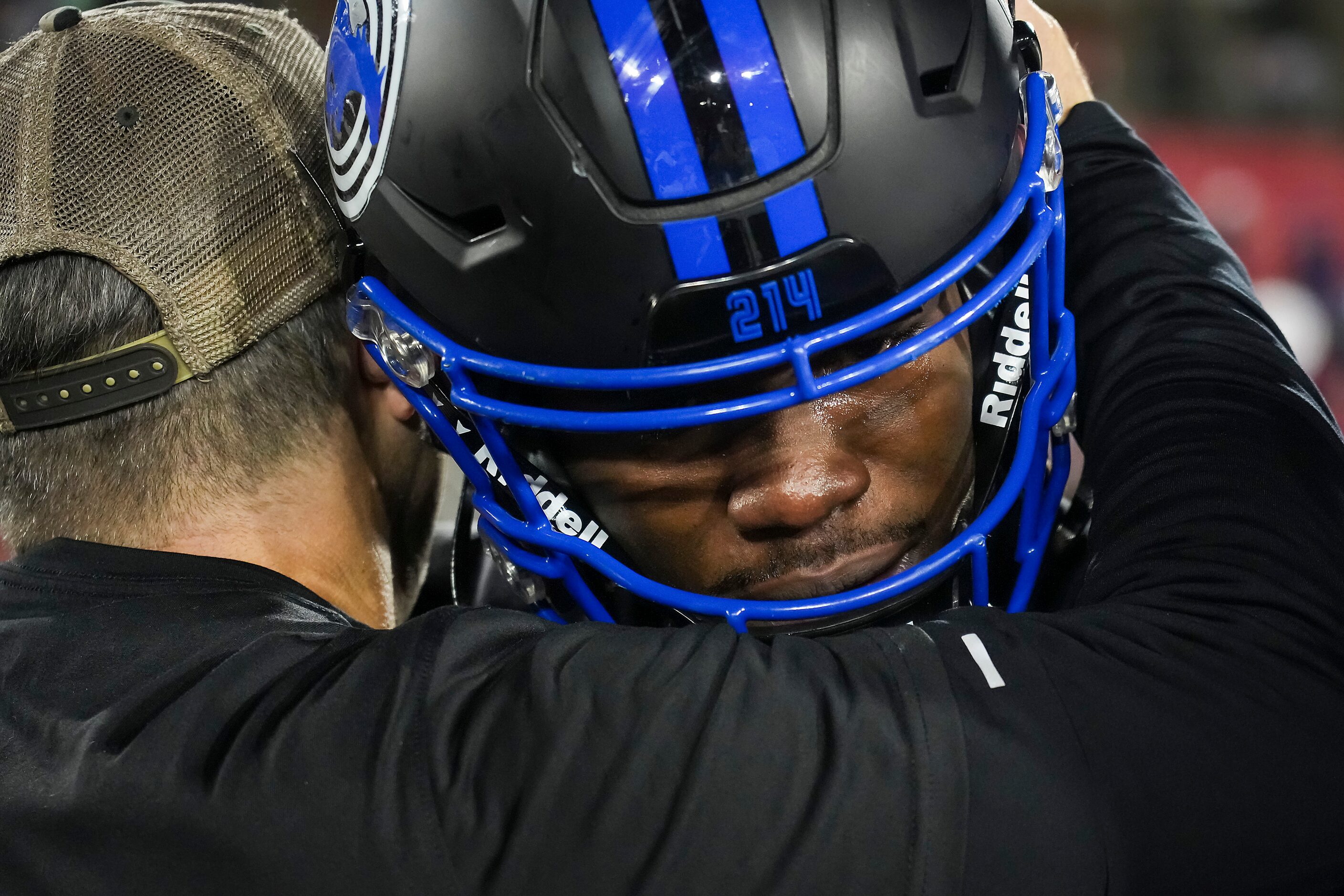 SMU wide receiver Rashee Rice hugs wide receivers coach Rob Likens after the playing of the...