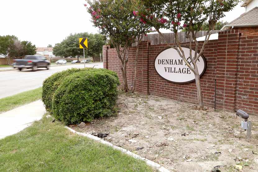 An entrance into the Denham Village neighborhood which shows the signage and incomplete...