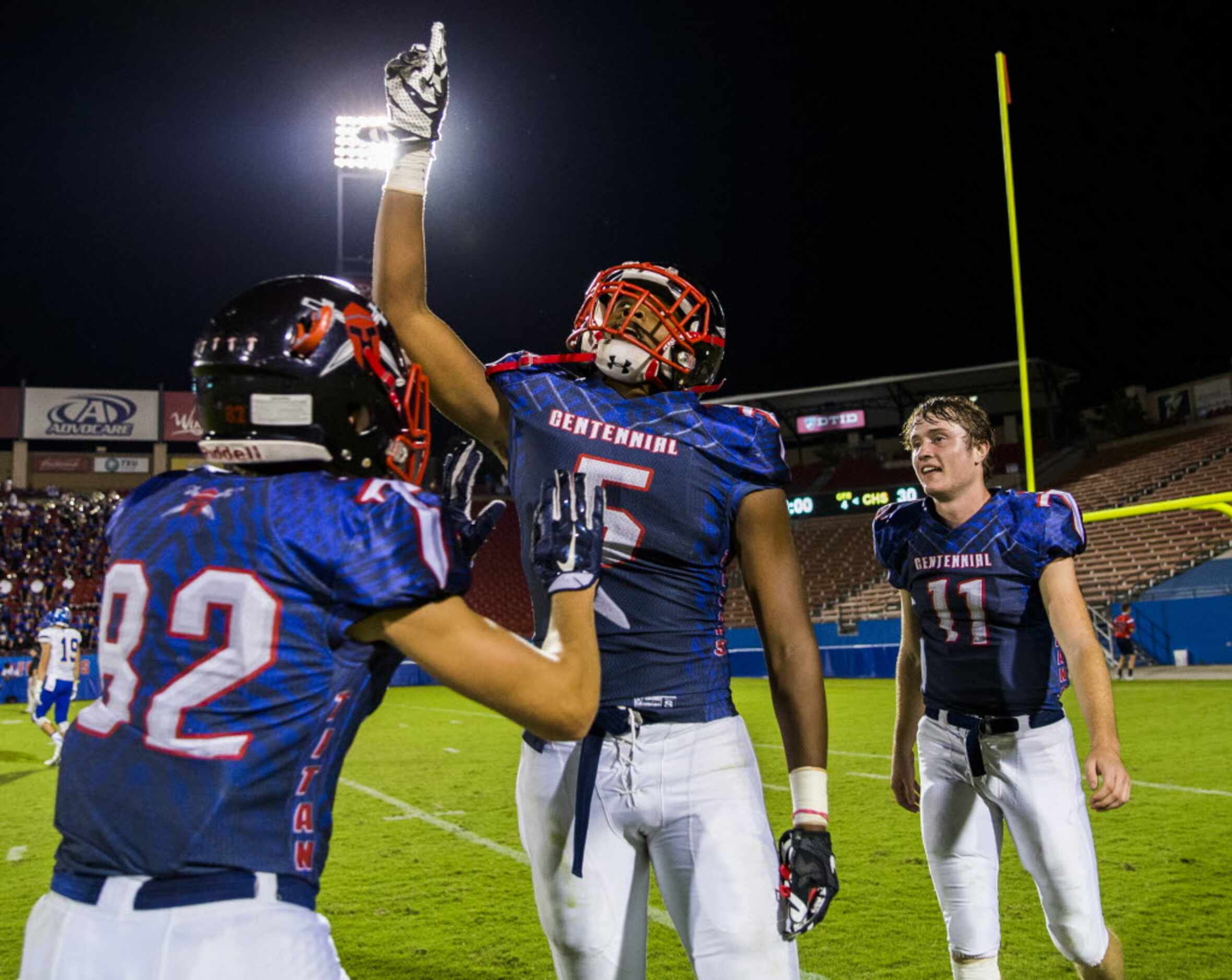 Frisco Centennial wide receiver Kenny Nelson (5) celebrates with team mates wide receiver...