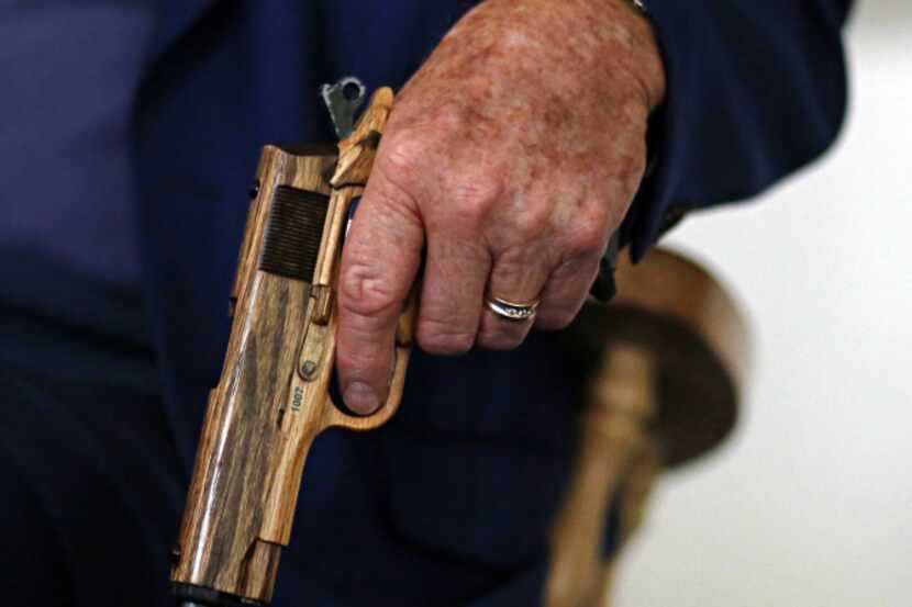 Howard, 82, who lives on a ranch near Prosper, gripped the gun-shaped handle of his cane as...