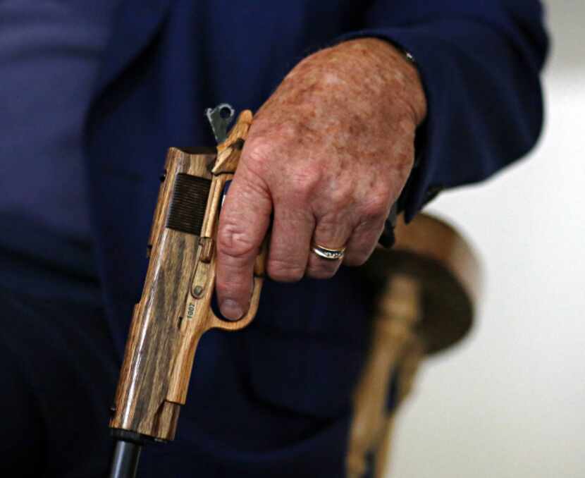 Howard, 82, who lives on a ranch near Prosper, gripped the gun-shaped handle of his cane as...
