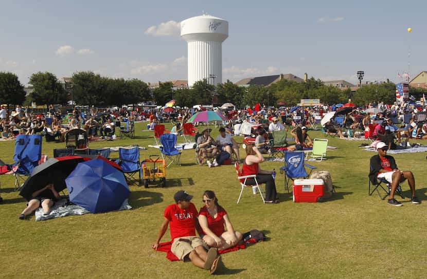 People prepare their viewing spots during the Kaboom Town Fourth of July celebration on...