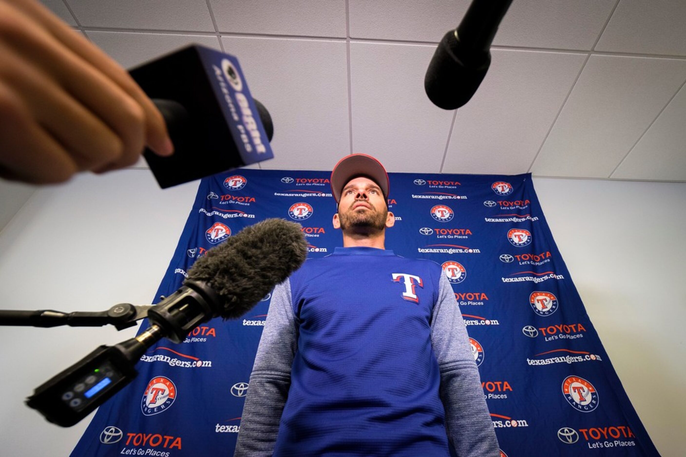 Texas Rangers manager Chris Woodward addresses the media before the first full squad spring...