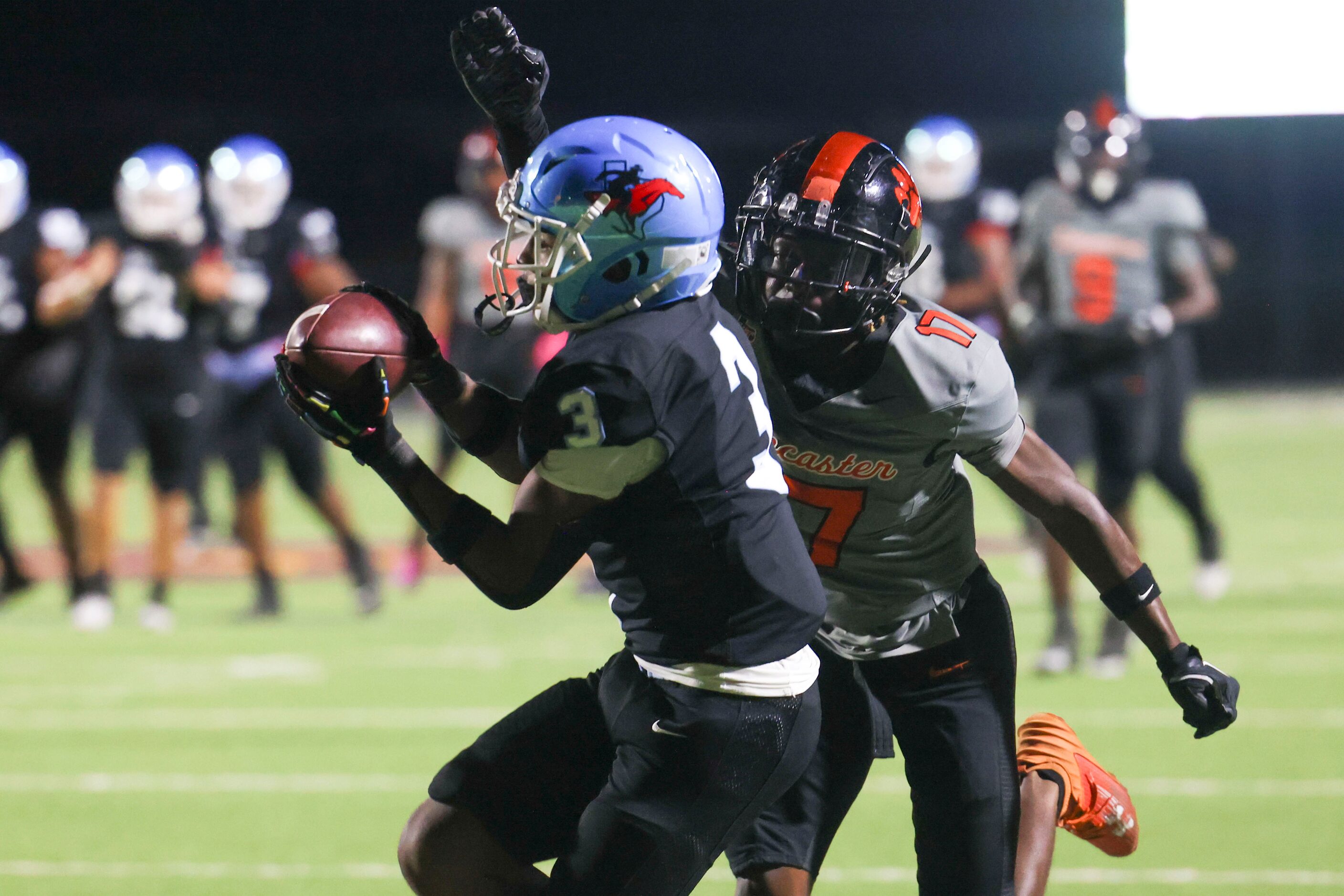 Skyline High’s Delvin Cook (3) receives a touchdown pass past Lancaster High’s Kainen Jones...