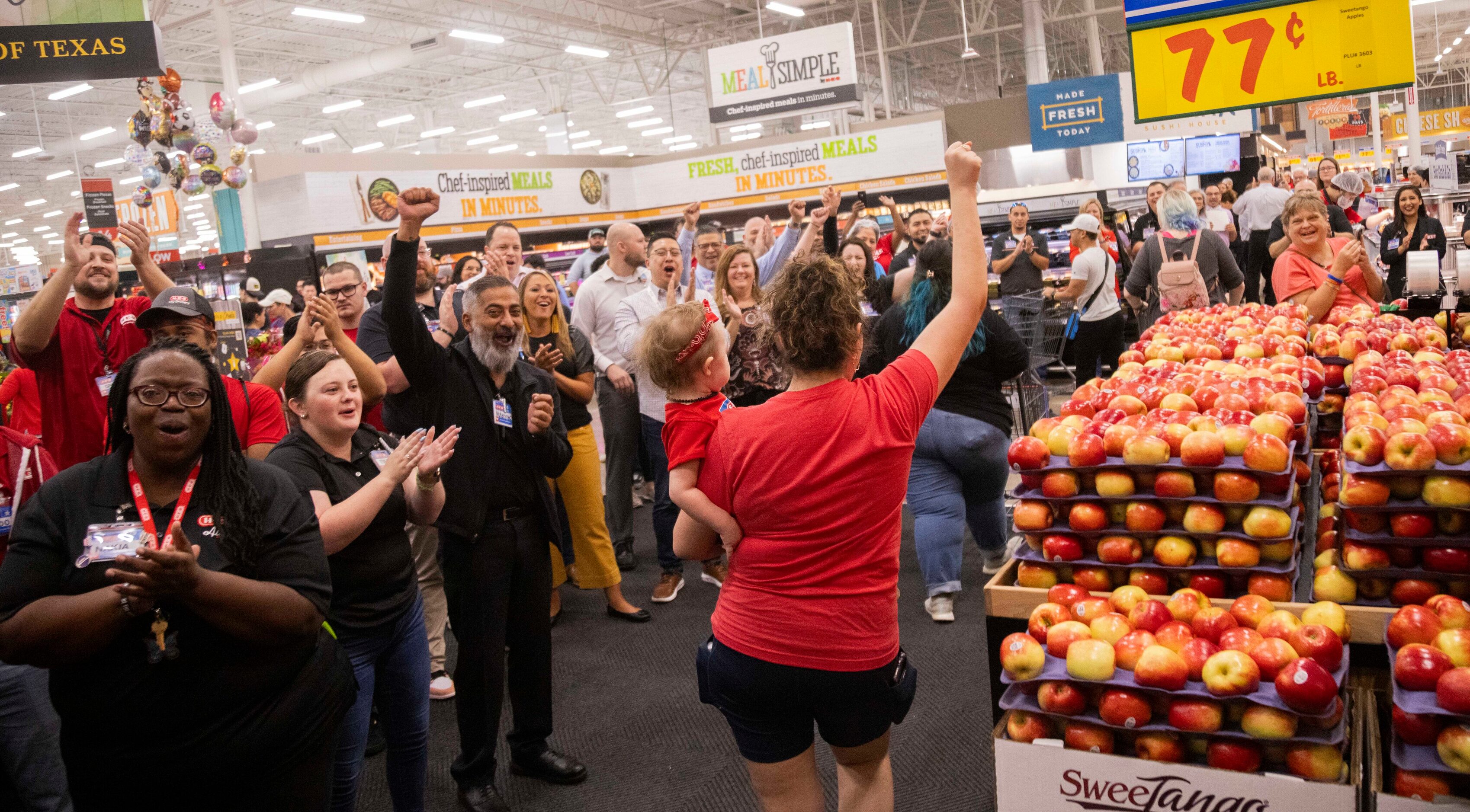 Ellie Woslager of Allen celebrates the grand opening of the H-E-B store in Allen while...