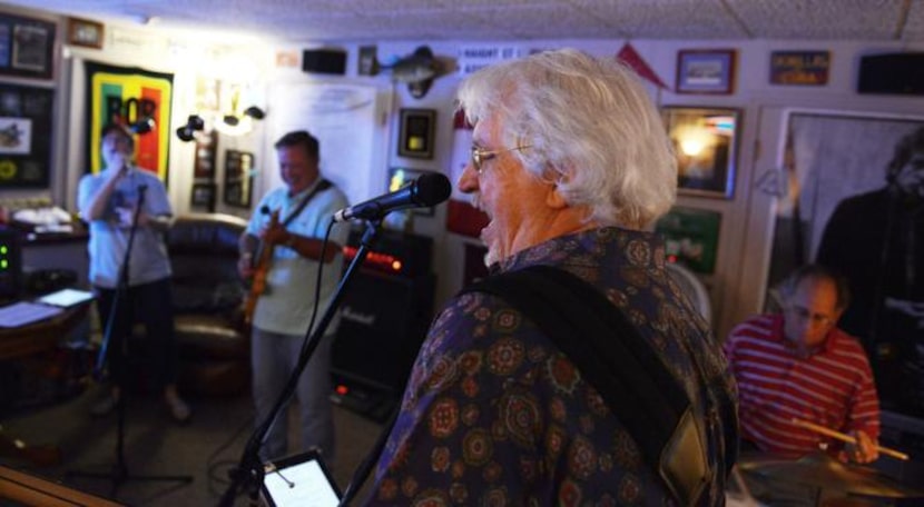 
Bassist Brad Young of the Catdaddies rehearses in the converted garage of Mark Sales in...