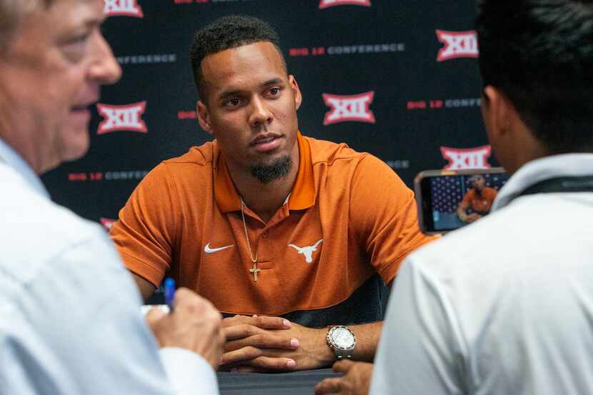 University of Texas wide receiver Collin Johnson speaks with reporters during the breakout...