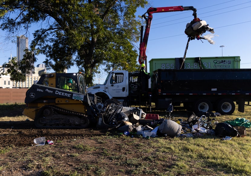 The city’s code compliance department, among other contractors, clear out the belongings...