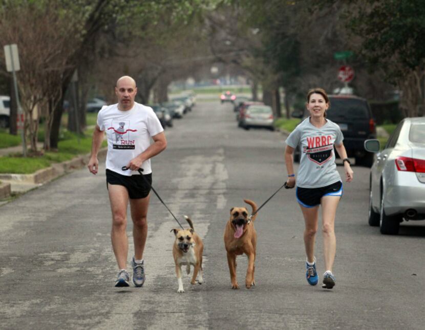 Michael Friedhoff and Angela Turnage run with their SPCA rescues, Nevada (left) and Shasta.