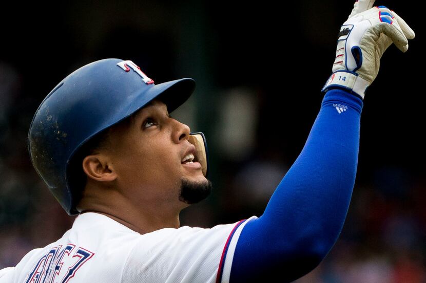 Texas Rangers center fielder Carlos Gomez (14) rounds the bases after hitting a home run...
