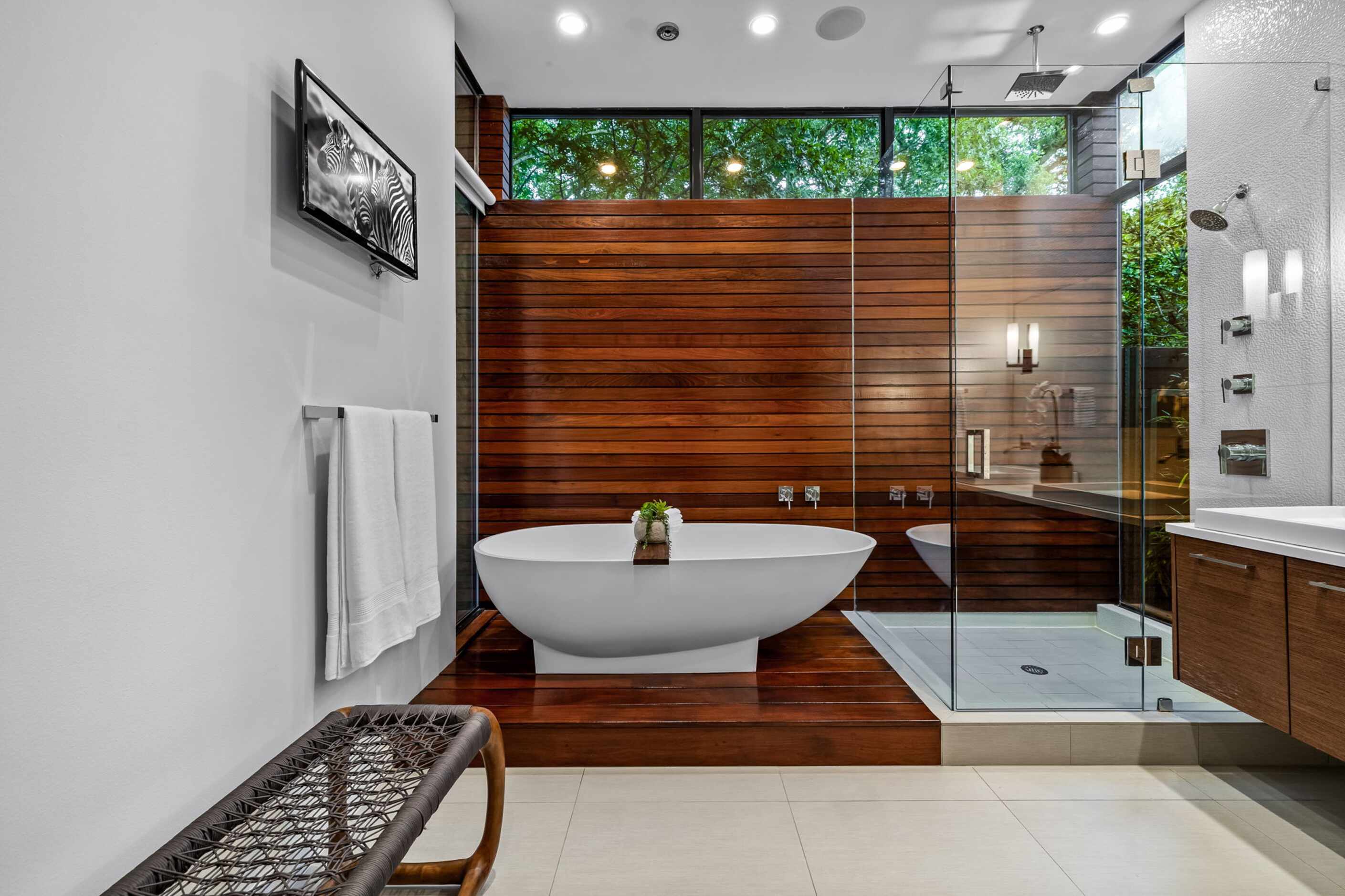 Contemporary bathroom with wood details, separate bathtub and shower