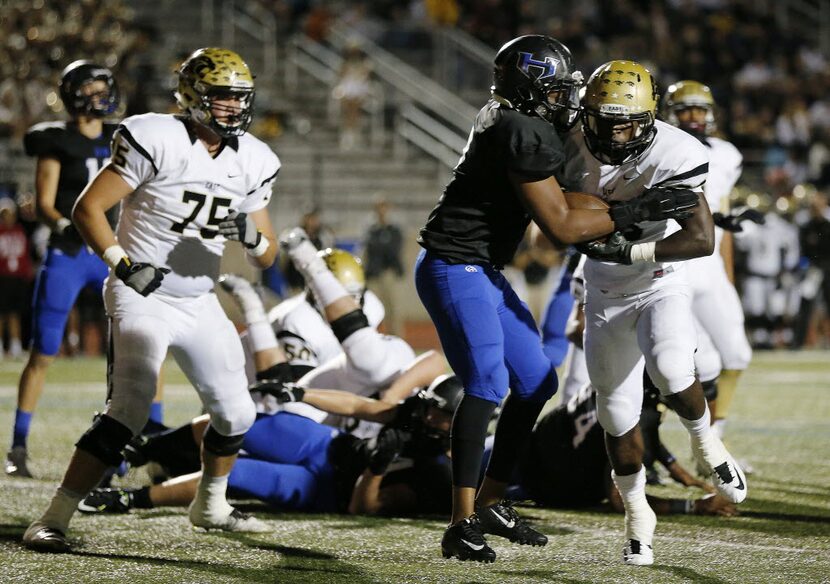 Plano East running back Desmond Bowden (28) gets by Hebron inside linebacker Kameron Isom...