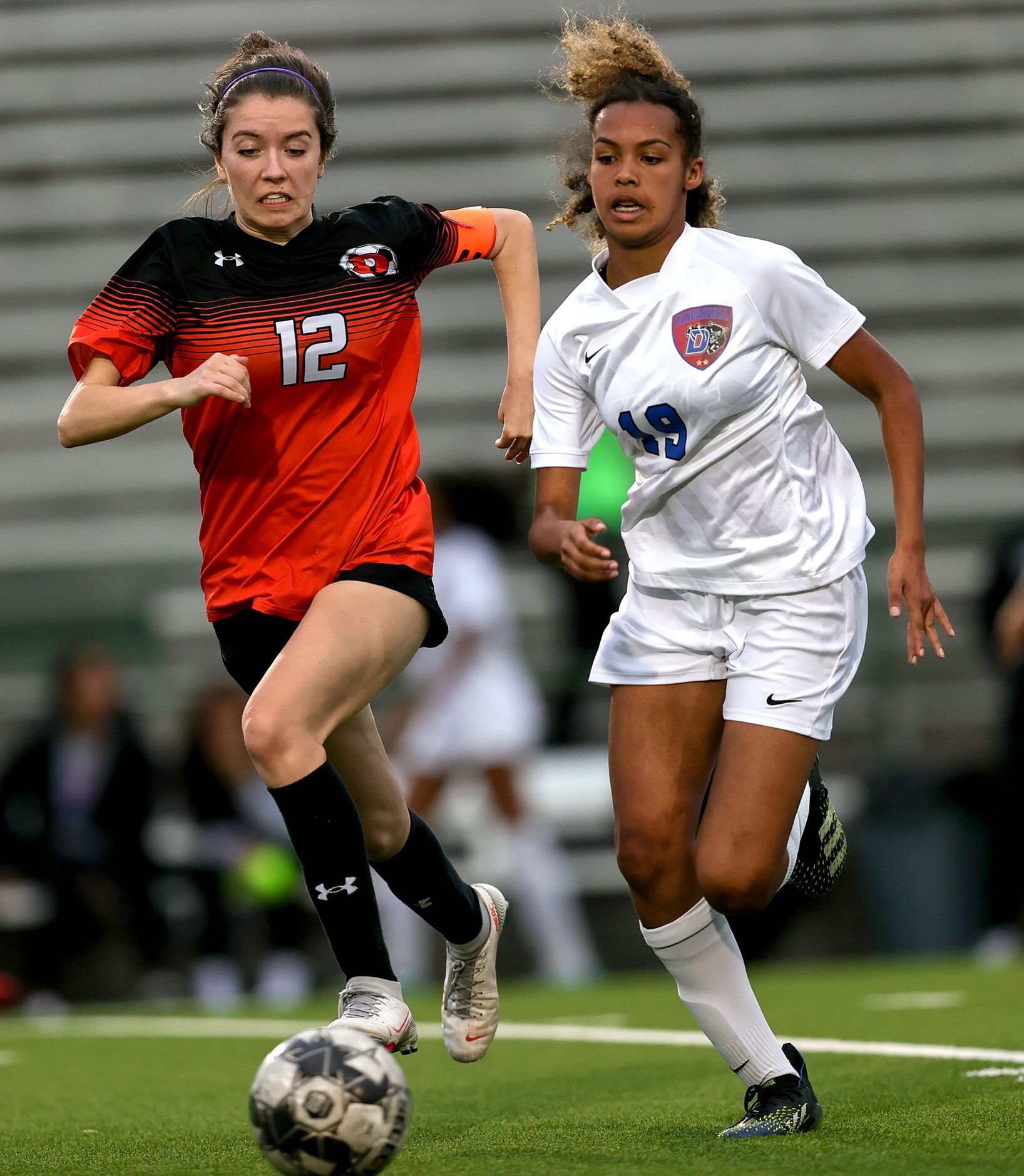 Rockwall Madelyn Weir (12) and Duncanville Marily Mbugua (19) try to chase down the ball...